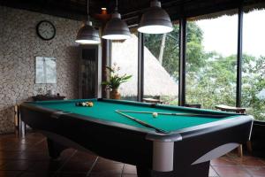 a billiard room with a green pool table at PURI BALI STANIA, Cisarua West Java in Cilama