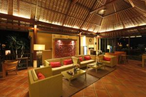 a lobby with couches and tables in a resort at PURI BALI STANIA, Cisarua West Java in Cilama