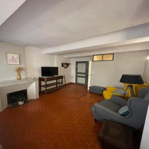 a living room with a couch and a fireplace at Maison de village centre Quinson in Quinson