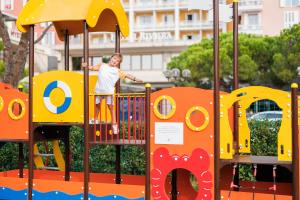 Um homem está de pé num parque infantil. em Wellness Hotel Apollo – Terme & Wellness LifeClass em Portorož