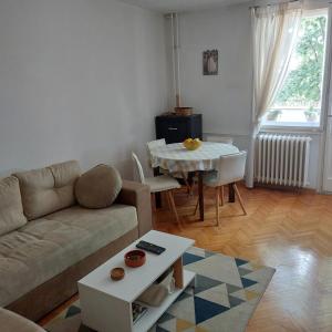 a living room with a couch and a table at Apartment ADA RB Belgrade in Čukarica