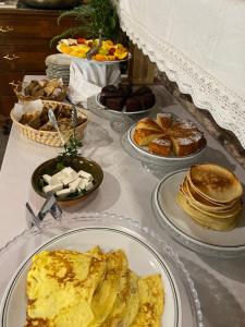 uma mesa coberta com pratos de pequeno-almoço e produtos de pastelaria em Corte Boero Bed&Breakfast em Capoterra