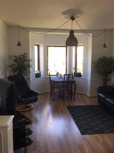 a living room with a table and chairs and a couch at Motel Villa Søndervang twin room in Harndrup