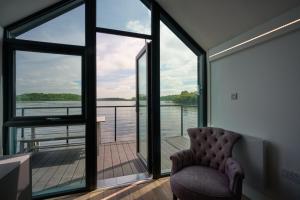 a room with a chair and a view of the water at Carrickreagh Bay in Blaney
