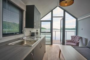 a kitchen with a sink and a view of the water at Carrickreagh Bay in Blaney