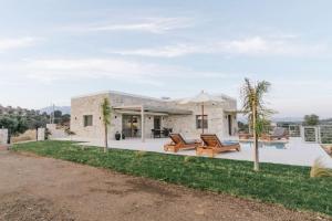 a stone house with a patio and a pool at Ramo dolivo Villa in Sívas