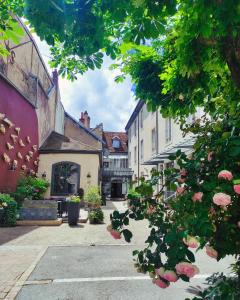 an empty street in a small town with buildings at Hôtel de Paris in Besançon