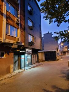 an empty parking lot in front of a building at City Park Suites City Center Corlu in Çorlu