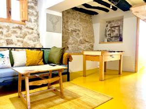 a living room with a couch and a table at El Retiro & GASTRO Vivencias in Sigüenza