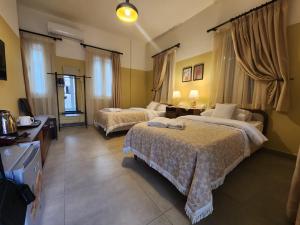a hotel room with two beds and a television at VICTORIA BOUTIQUE HOTEL in El Mîna
