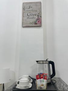 a coffee maker sitting on a counter with a picture at Pinkys Guest House in Allen