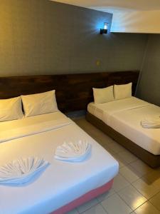 Postel nebo postele na pokoji v ubytování Hotel Sri Sutra PJ 222