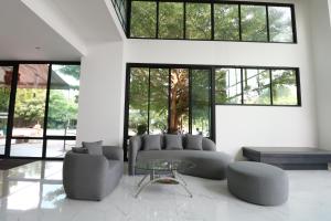 - un salon avec un canapé et une table en verre dans l'établissement S4 Nai Yang Beach - SHA EXTRA PLUS, à Nai Yang Beach