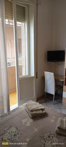 a bedroom with a bed and a television and a window at Bed and Breakfast Almaran in Trapani