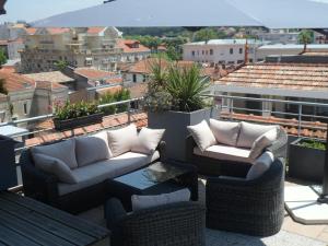 a patio with couches and tables on a roof at Residhome Arcachon Plazza in Arcachon