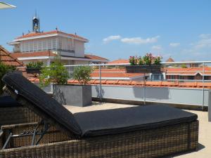 a black couch on the roof of a building at Residhome Arcachon Plazza in Arcachon