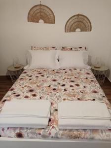 a bedroom with a bed with two tables at Casa Raios de Sol in Burgau