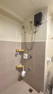 a bathroom with a shower with a shower head at Ezra Condo in Avida Riala in Cebu City