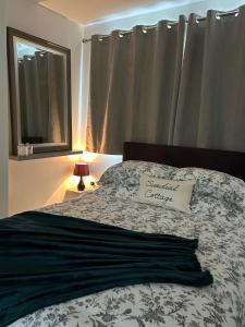 a bedroom with a bed with a pillow and a window at Sundial Cottage in Newton Abbot