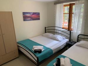 a bedroom with two beds and a window at Yalos Studio in Stavros