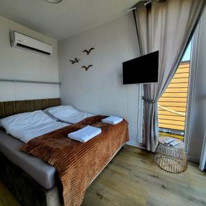 1 dormitorio con 1 cama con pájaros en la pared en Apartament na wodzie Augustów en Augustów