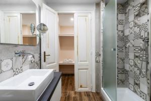 a bathroom with a sink and a shower at Onda Marina Suites in Cagliari