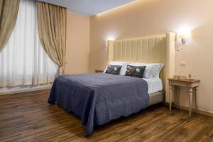 a hotel room with a bed and a window at Onda Marina Suites in Cagliari