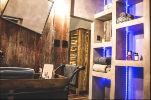 a bathroom with a sink and a wooden wall at Maison de vacances atypique in Guérande