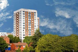 a tall white building with trees in front of it at Central Retreat- A Cosy 2 Bedroom Flat with View in L3 in Liverpool