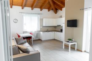 a kitchen and living room with a couch and a table at AB&C Arco Bed And Camping in Arco