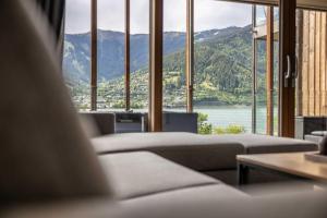 a living room with couches and a view of a mountain at Bellevue Residences - Luxurious Lakeside Apartments in Zell am See