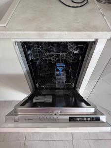 a dishwasher in a kitchen with its door open at Horizon Apartament Gut in Sveti Vlas