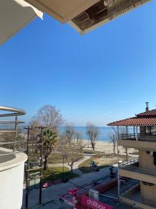 a view of the beach from the balcony of a building at Ammos Korali in Olympiaki Akti