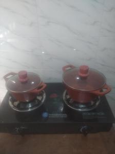 two pots sitting on top of a stove at Chinaka guest house in Lagos