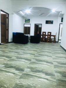 an empty room with chairs and tables and a floor at Ananyah Villa in Trincomalee