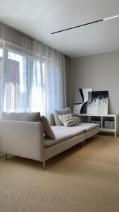 a bedroom with a bed and a large window at Amber Shore Apartment in Liepāja +27 photos