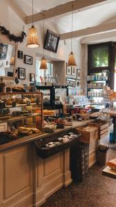 a bakery with a counter with many different types of food at Amber Shore Apartment in Liepāja