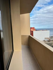 a balcony with a view of the ocean at HostJimeno PRIMAVERA in La Garita +3 photos