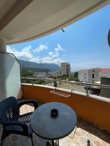 a balcony with a table and chairs and a view at Villa Ivanovic in Budva