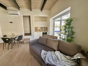 a living room with a couch and a table at Modern Designer Stay near Sliema Seafront in Il-Gżira