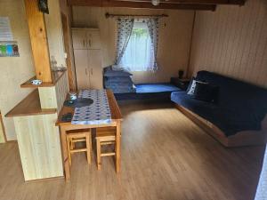 a living room with a couch and a table at Domek u Marysi in Bukowiec