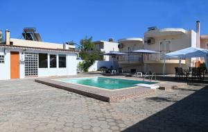 a swimming pool in front of a house at Oasis Lower Ground Floor Apartment in Argos