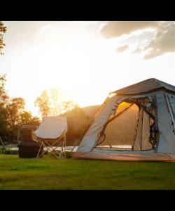 namiot i krzesło na polu w obiekcie Camping Garden Park PITCHES w mieście Radovljica