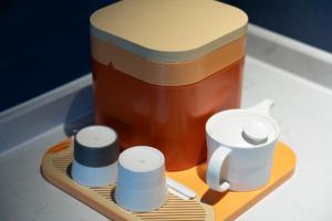 a wooden tray with a jar of honey and two rolls of thread at Atour Hotel Nanhu Jiaxing in Jiaxing