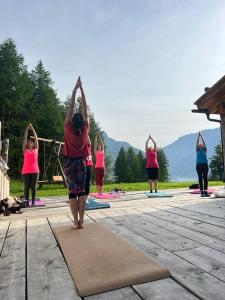 a group of people doing yoga on a deck at Appartamenti GG - Big and central in Livigno