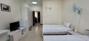 Voodi või voodid majutusasutuse Hello inn 哈囉行旅屏東館 toas