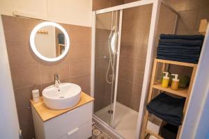 a bathroom with a sink and a shower with a mirror at Superb T4 Souplex in Giens in Hyères