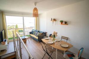 a living room with a table and a couch at Superb T4 Souplex in Giens in Hyères