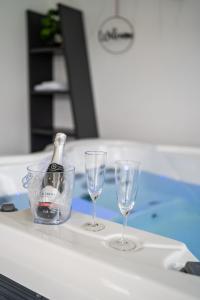 a bottle of champagne and two glasses on a table at Apartmaji Živa in Gornja Radgona +24 photos