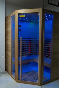 a wooden enclosure with blue lights in a room at Apartmaji Živa in Gornja Radgona